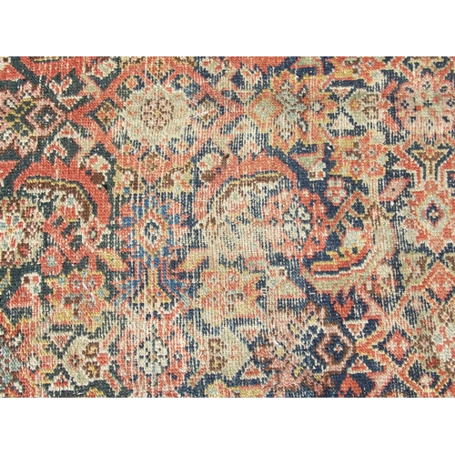 114 - A Persian Kellah runner with repeating geometric pattern on a red ground, 472 by 174cms.