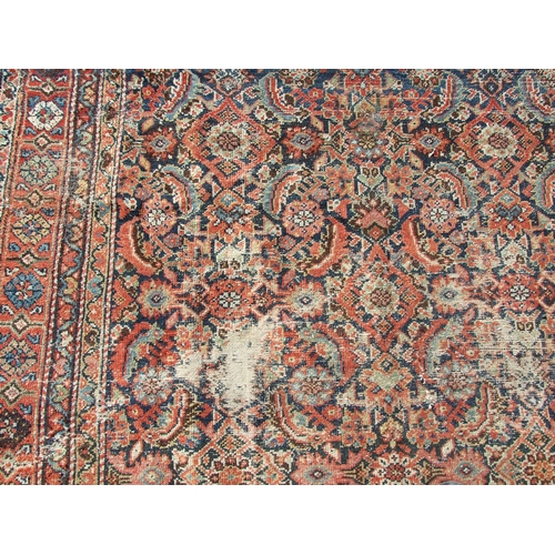 114 - A Persian Kellah runner with repeating geometric pattern on a red ground, 472 by 174cms.