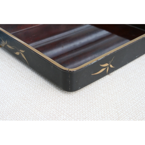 613 - A Japanese Meiji period black lacquer and chinoiserie decorated writing box, the cover decorated wit... 