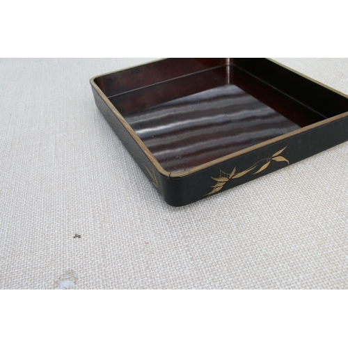 613 - A Japanese Meiji period black lacquer and chinoiserie decorated writing box, the cover decorated wit... 