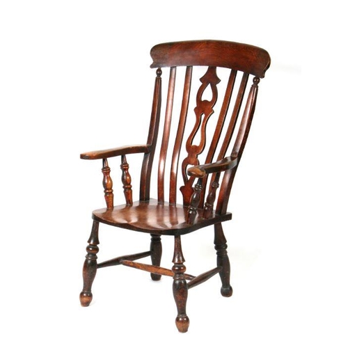 1238 - A late Victorian beech and elm farmhouse kitchen armchair with turned front legs joined by stretcher... 