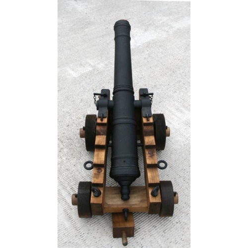 130 - An ornamental 18th century style cannon. Having a black painted reinforced concrete tapering barrel ... 