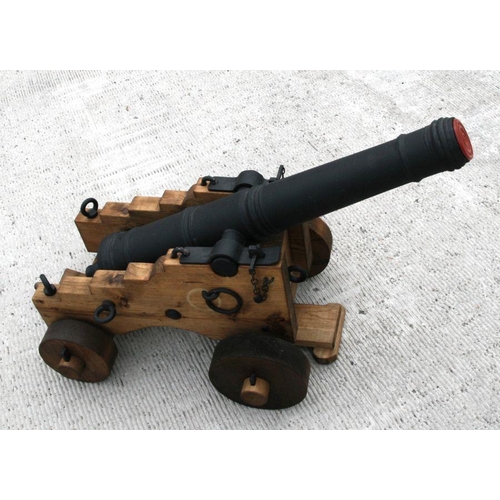 130 - An ornamental 18th century style cannon. Having a black painted reinforced concrete tapering barrel ... 