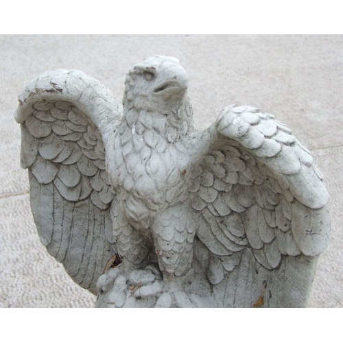 14 - A large pair of stoneware garden eagles perched on a sphere with their wings outswept, 97cms high (2... 