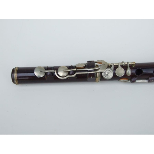 162 - A Rudall Carte & Co. Ltd rosewood flute, No. 5409, 67cms long.