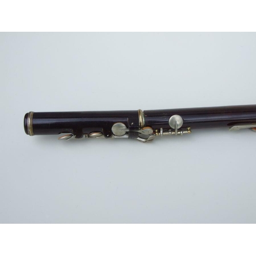 162 - A Rudall Carte & Co. Ltd rosewood flute, No. 5409, 67cms long.