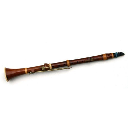 165 - A 19th century pearwood and ivory clarinet by Metzler & Co. London, 59cms long.  APHA registrati... 