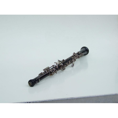 174 - A three-piece ebony oboe by F Busson, 60cms long, cased.