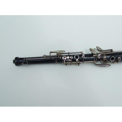 174 - A three-piece ebony oboe by F Busson, 60cms long, cased.