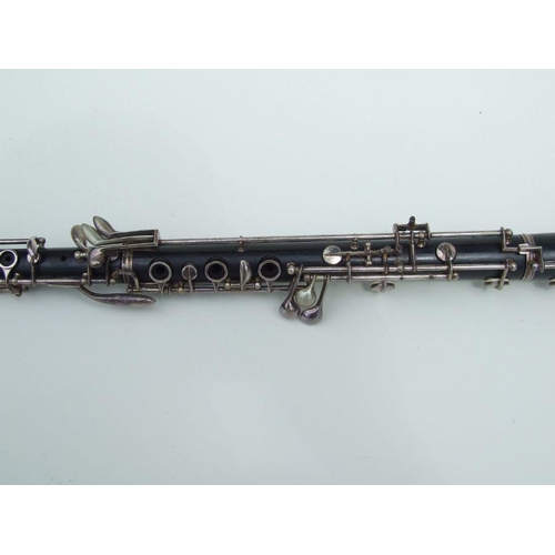 174 - A three-piece ebony oboe by F Busson, 60cms long, cased.