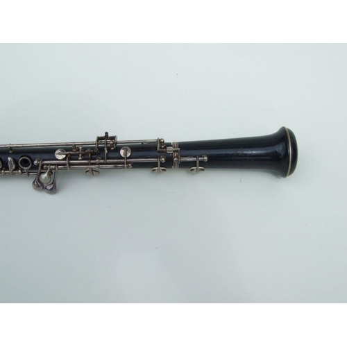 174 - A three-piece ebony oboe by F Busson, 60cms long, cased.