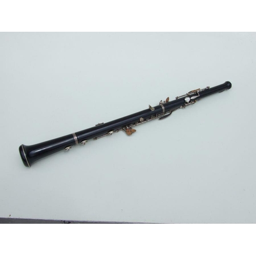 174 - A three-piece ebony oboe by F Busson, 60cms long, cased.