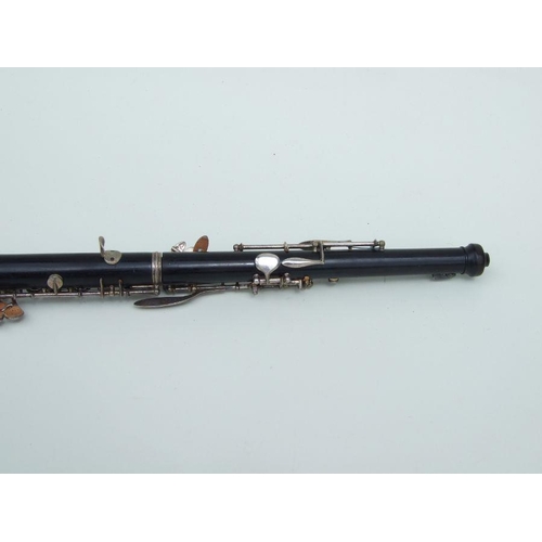 174 - A three-piece ebony oboe by F Busson, 60cms long, cased.