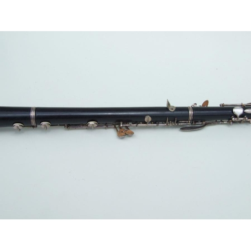 174 - A three-piece ebony oboe by F Busson, 60cms long, cased.