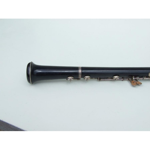 174 - A three-piece ebony oboe by F Busson, 60cms long, cased.