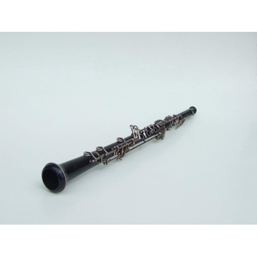 174 - A three-piece ebony oboe by F Busson, 60cms long, cased.