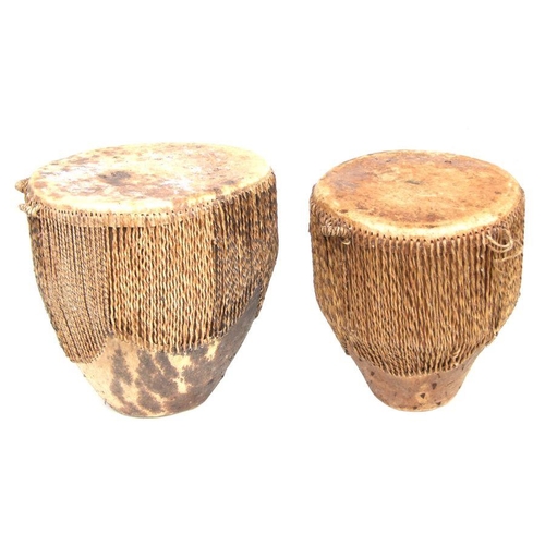 200 - Two African hide drums, the largest 36cms high; together with two Tongan Kankobela (4).