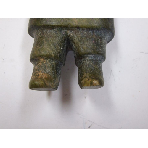 210 - An Inuit carved stone figure depicting a man with outstretched arms, 11cms high.