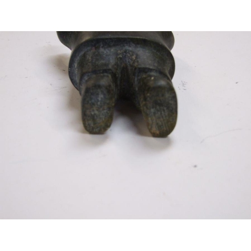 210 - An Inuit carved stone figure depicting a man with outstretched arms, 11cms high.