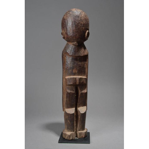 214 - A Lobi standing male figure, Burkina Faso with a small hair knot to the back of the head and with lo... 