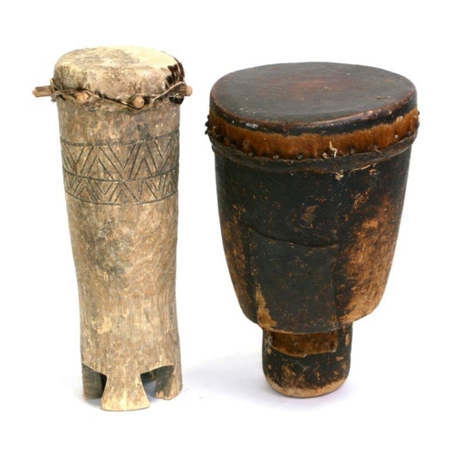 225 - A tribal ethnic drum with leather drum skin, 32cms diameter; together with a similar hollow wood exa... 