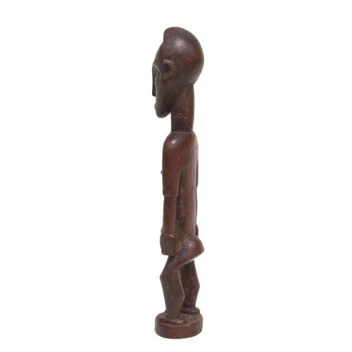 228 - African Art / Tribal Art:  a carved wooden female figure, 43cms high.