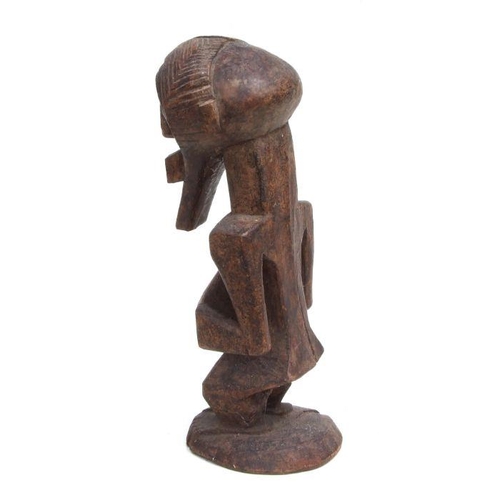 229 - African Art / Tribal Art:  a carved wooden Songye male figure, 38cms high.