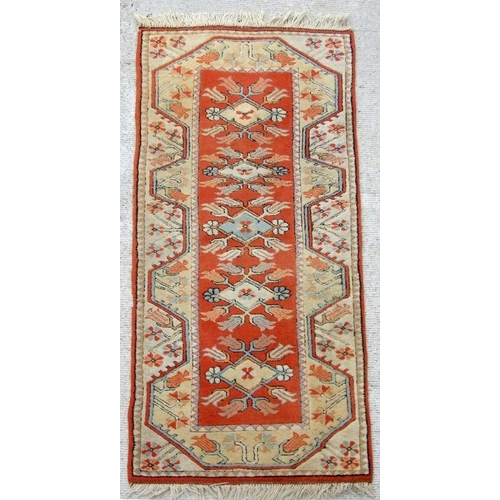 280 - A Persian hand knotted woollen runner with stylised tulip design within geometric borders, on a crea... 