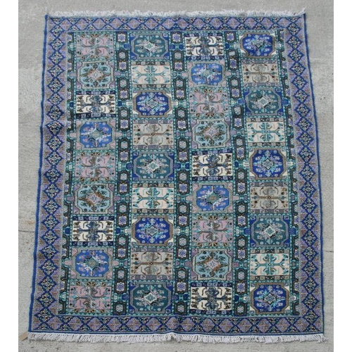 283 - A Persian style carpet with repeating geometric patterns on a blue ground, 314 by 203cms.