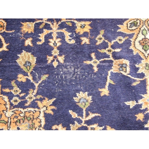 300 - A Turkish hand knotted woollen rug, the central gul within stylised floral borders, on a beige groun... 