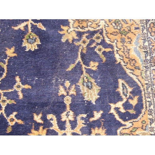 300 - A Turkish hand knotted woollen rug, the central gul within stylised floral borders, on a beige groun... 