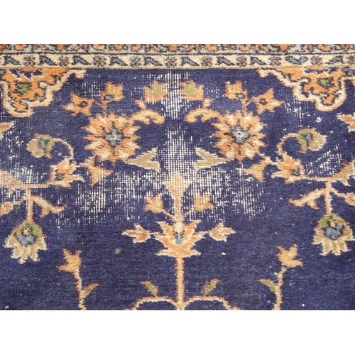 300 - A Turkish hand knotted woollen rug, the central gul within stylised floral borders, on a beige groun... 