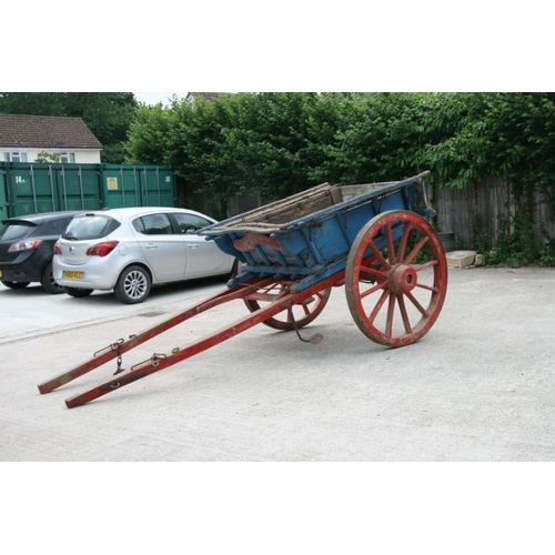 4 - A traditional horse drawn tipping cart with wooden shafts, steel and wooden cartwheels and bears pla... 