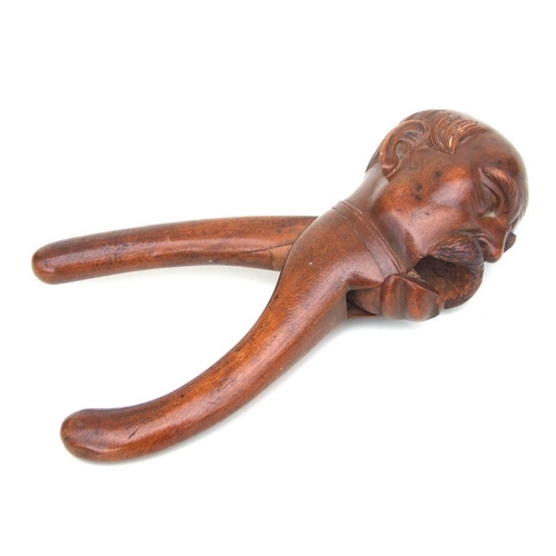 412 - A treen nutcracker carved in the form of Otto von Bismarck , 20cms high.