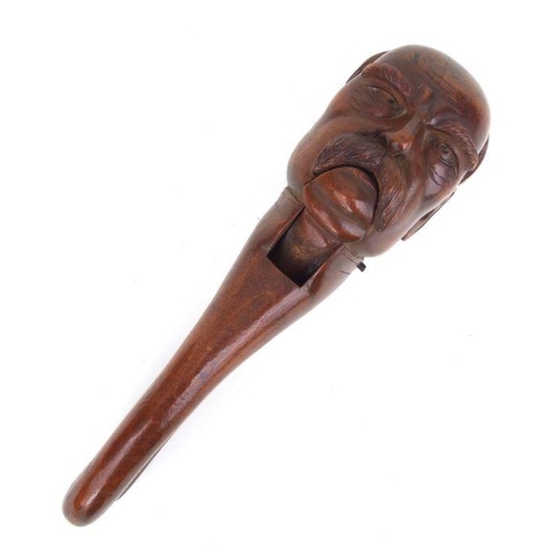 412 - A treen nutcracker carved in the form of Otto von Bismarck , 20cms high.