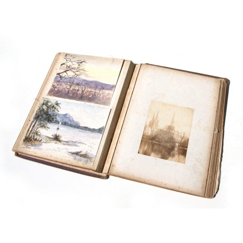 46 - A Victorian scrap album containing various watercolours of subjects to include landscapes, botanical... 