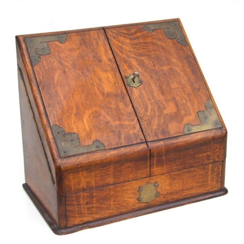 482 - A Victorian brass mounted oak stationery box with hinged sloped front enclosing a fitted interior wi... 