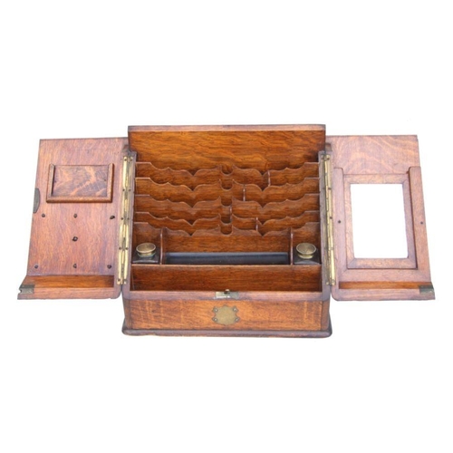 482 - A Victorian brass mounted oak stationery box with hinged sloped front enclosing a fitted interior wi... 