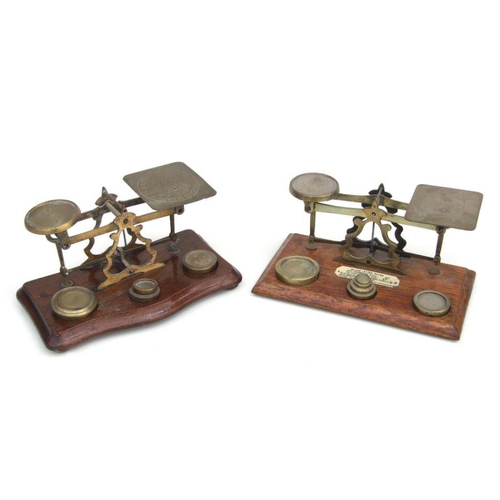 485 - A set of late 19th / early 20th century South African brass postal scales and weights on a shaped oa... 