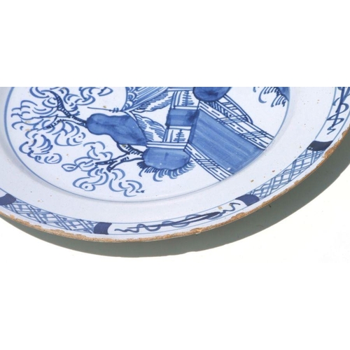 71 - A pair of Delft blue & white plates with unusual landscape scenes depicting a tent beside a tree... 