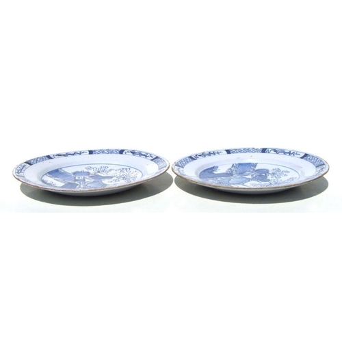 71 - A pair of Delft blue & white plates with unusual landscape scenes depicting a tent beside a tree... 