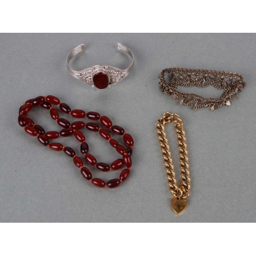 759 - A quantity of costume jewellery to include a rolled gold padlock bracelet, a cherry amber bead neckl... 