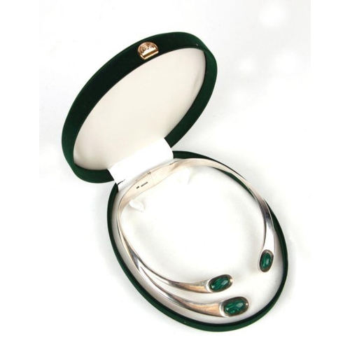 763 - A sterling silver hinged torque necklace set with oval malachite cabochons, 131g.