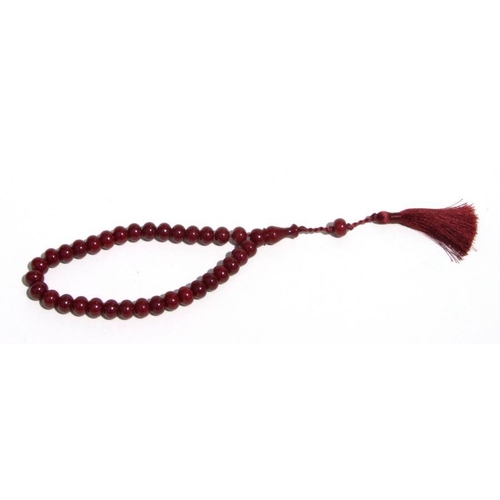 776 - A cherry amber Bakelite style string of worry beads.