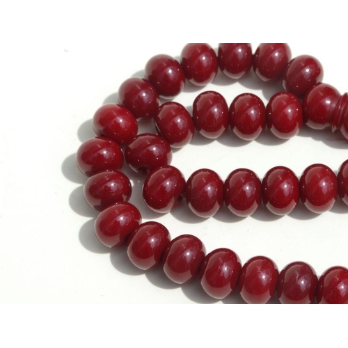 776 - A cherry amber Bakelite style string of worry beads.