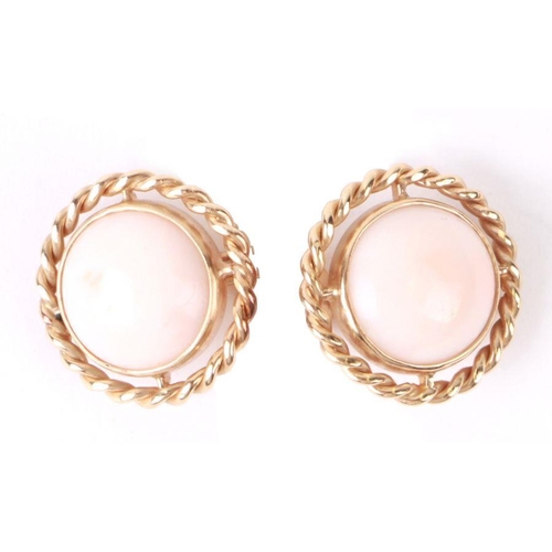 779 - A pair of yellow metal (tests as gold) clip-on earrings set with coral cabochons, total weight 9g.