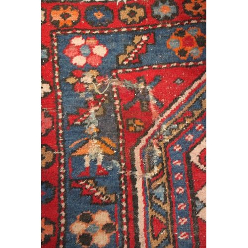 287 - A Persian Azari hand knotted woollen runner with five stylised guls within floral borders, on a blue... 