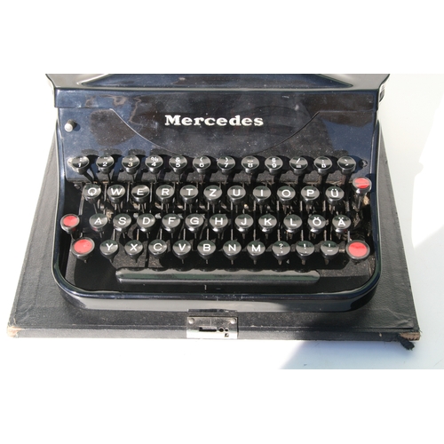 410 - A vintage Mercedes portable typewriter.