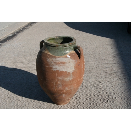 35 - A large Mediterranean terracotta two-handled olive jar with green glazed banded rim, 55cms high.