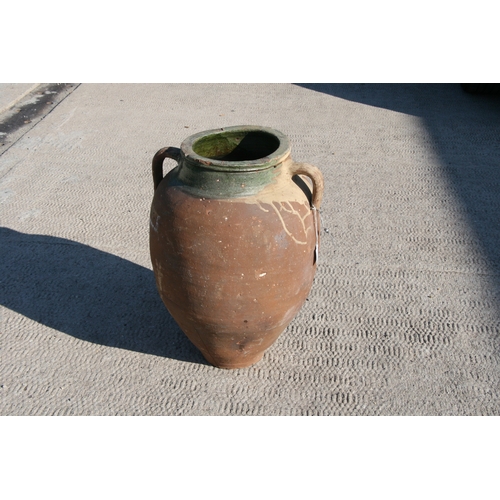 35 - A large Mediterranean terracotta two-handled olive jar with green glazed banded rim, 55cms high.